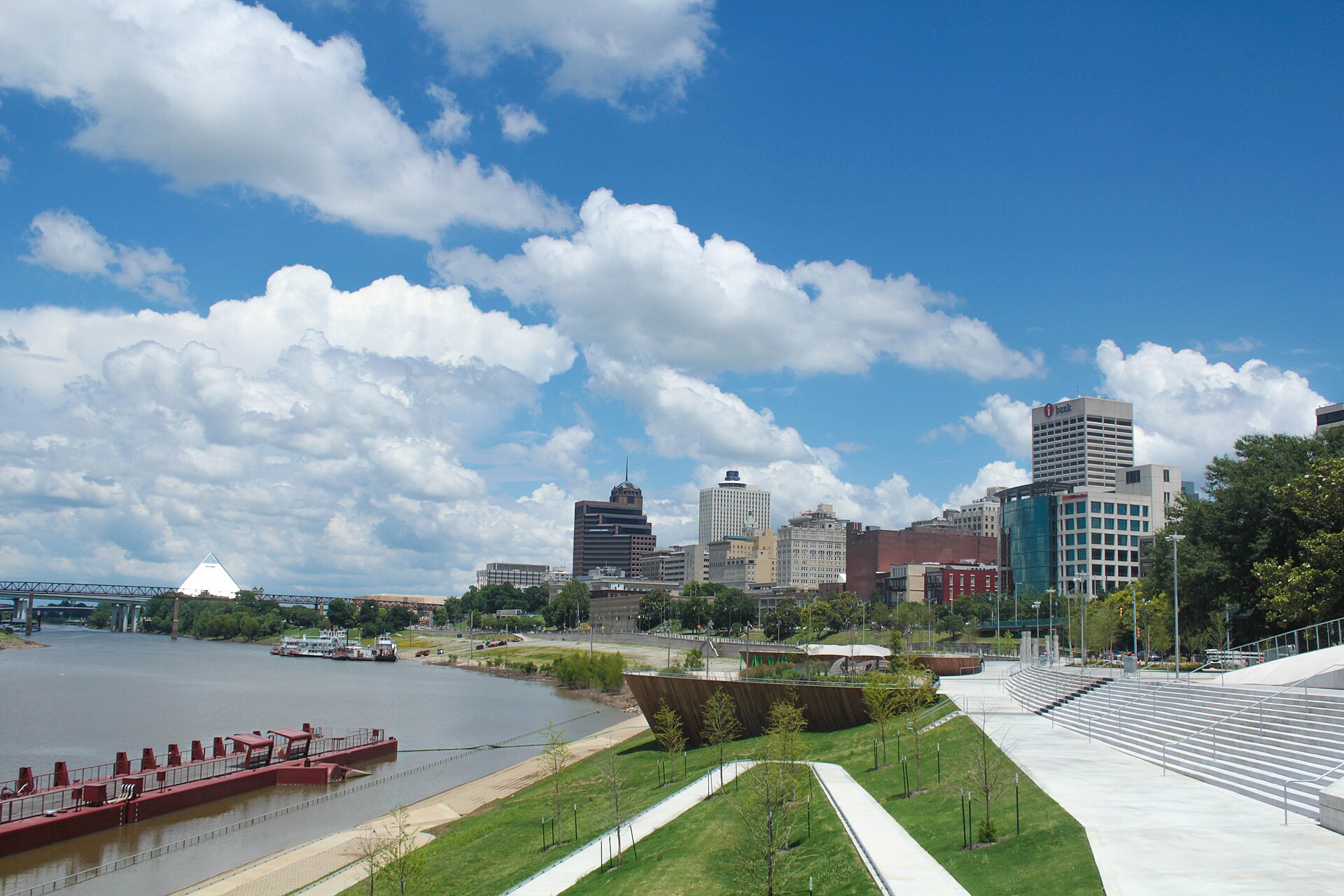 Memphis riverfront park and downtown skyline under a blue sky with clouds